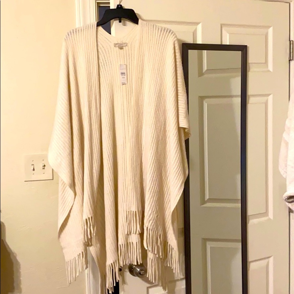 Fringed cream sweater poncho